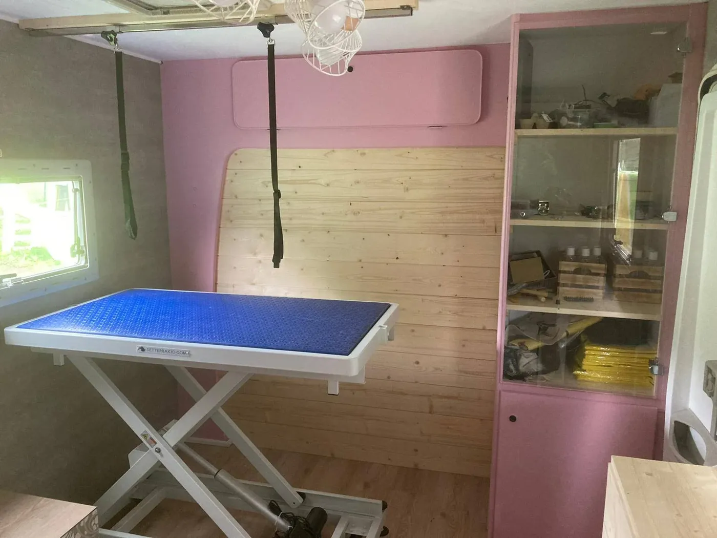 Intérieur du camping-car CHAT'MALLOW & CO aménagé en salon de toilettage avec table réglable